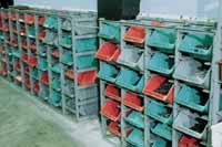 Plexton hopper containers in racks in warehouse